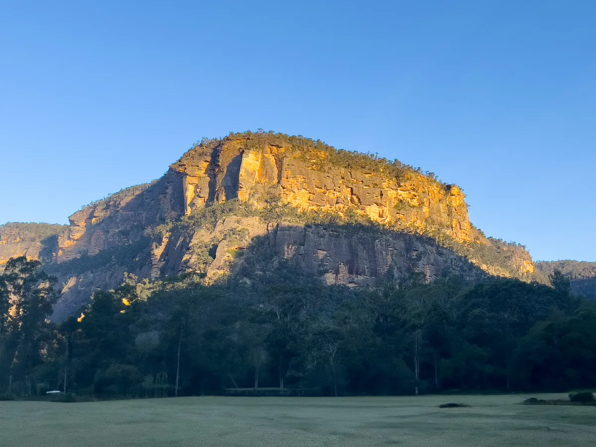 The escarpment surrounding Glen Davis glows in the early morning sun.