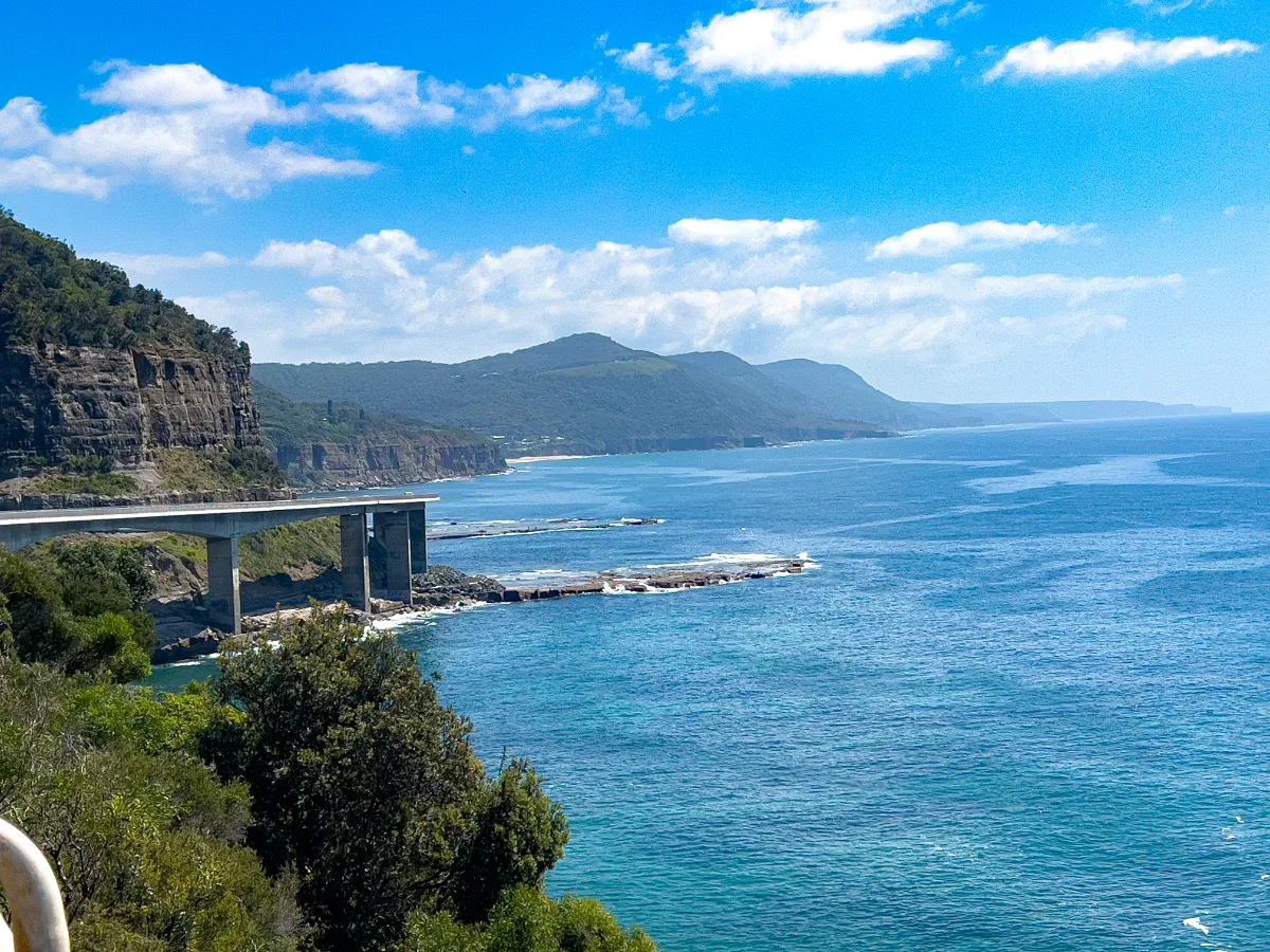 Looking south along the Sea Cliff Bridge; the azure waters extend to the horizon.