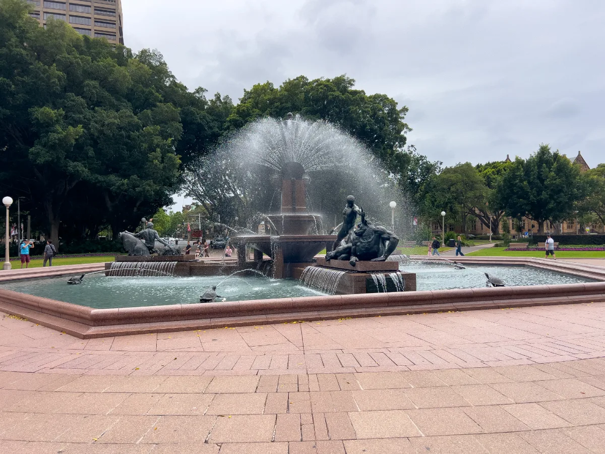 The Archibald Fountain in Hyde Park provides a vibrant and contrasting element with its sculptures and flowing water.