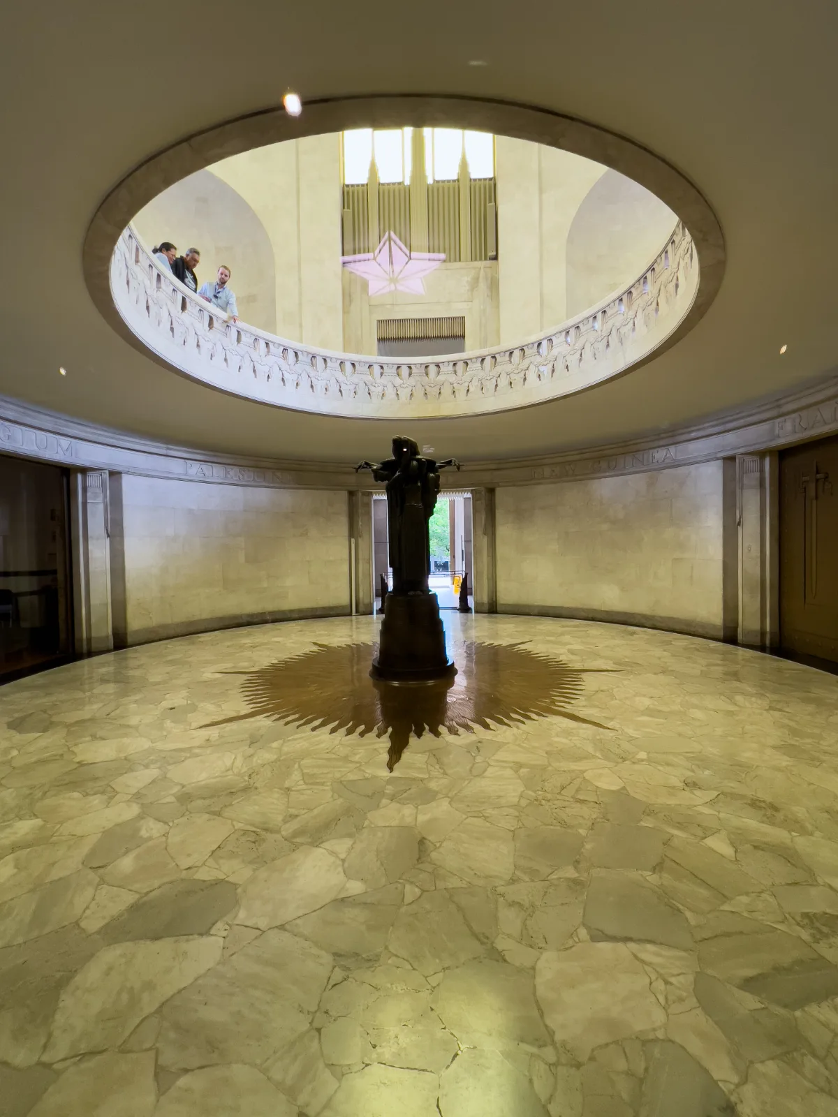 The central sculpture inside the ANZAC Memorial, bathed in light, encourages visitors to contemplate the sacrifices made.