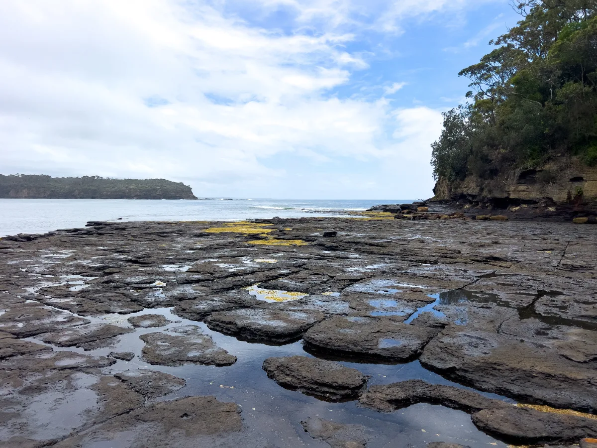 The impressive rock plateau stretches out into the ocean, a testament to nature's artistry.