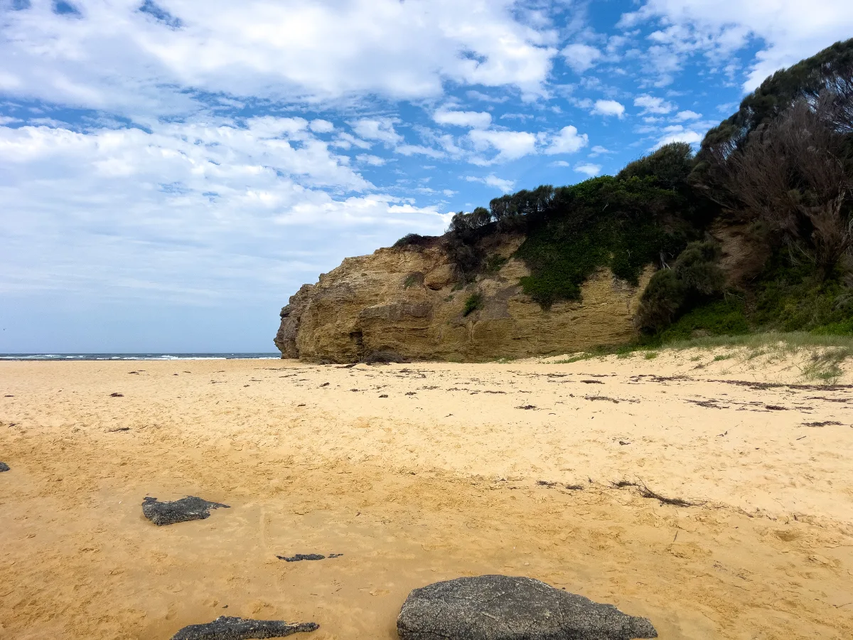 Congo Beach: The sandstone cliffs provide a rugged backdrop to the otherwise tranquil scene.