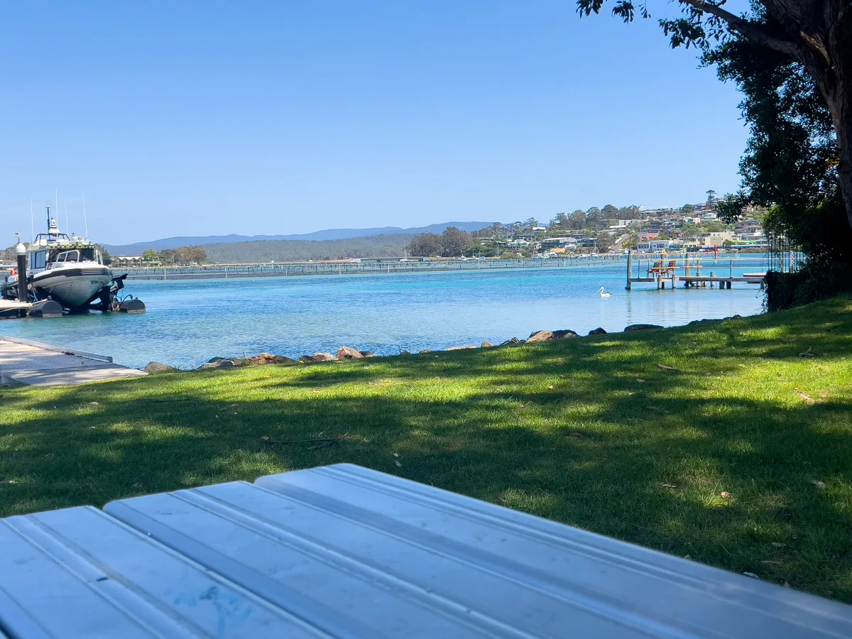 A perfectly positioned picnic table overlooks the tranquil waters of Merimbula Bay.