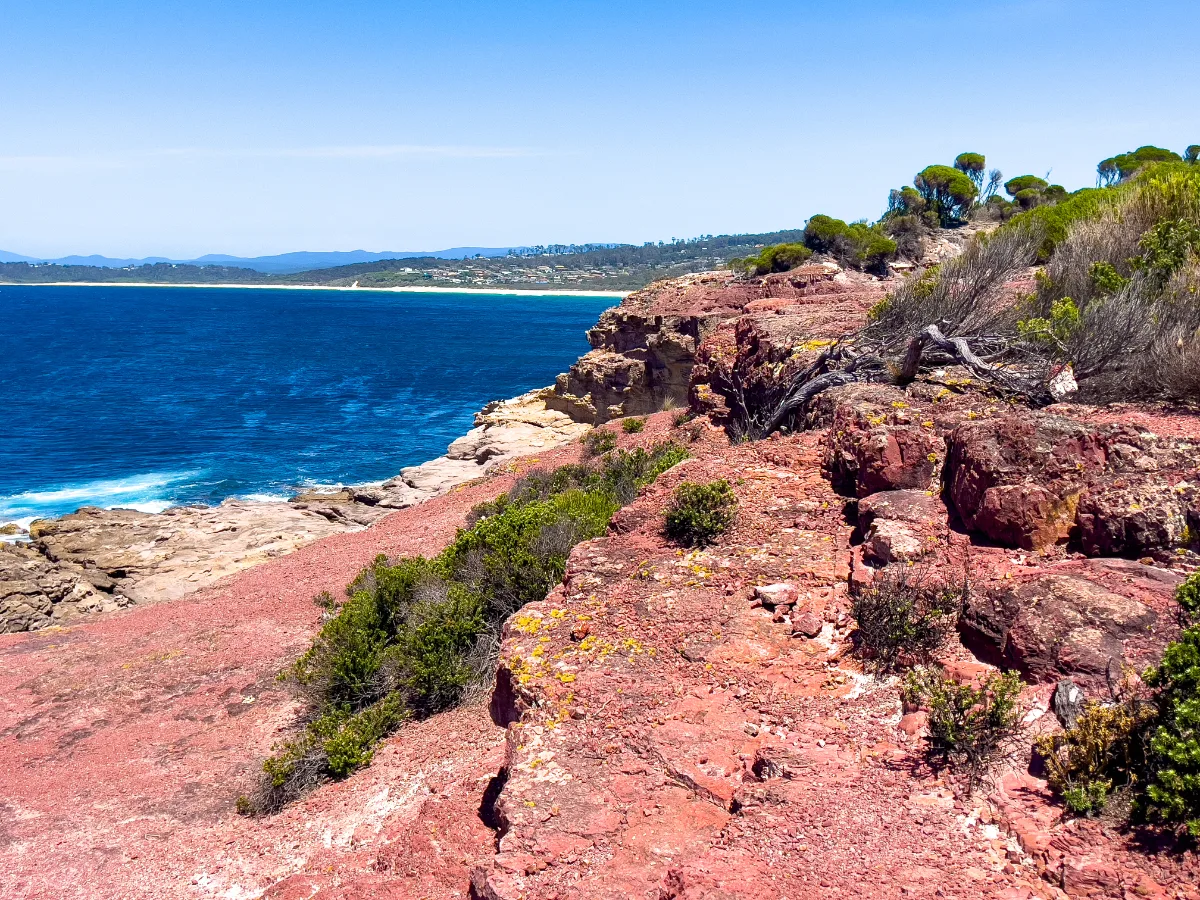 Looking out over the cliffs, where the red rock meets the sea.
