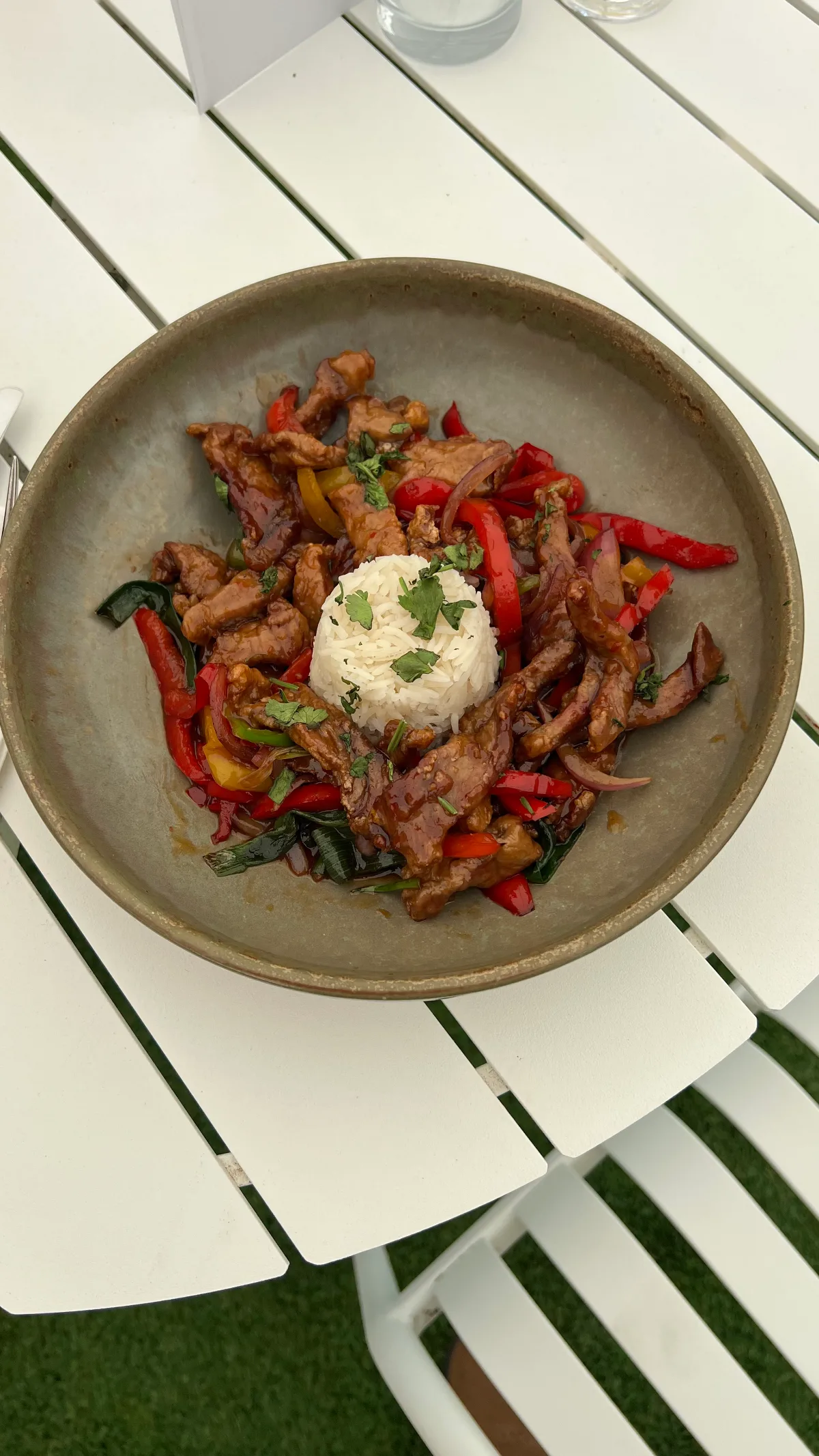 A flavorful pork dish with red peppers and rice.