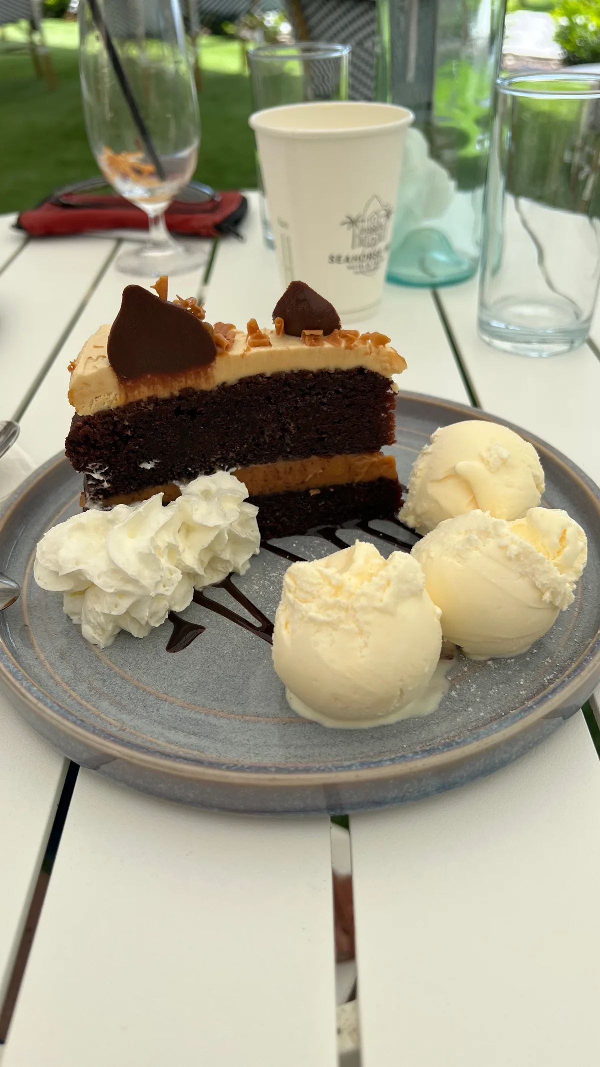 Chocolate caramel cake, complete with ice cream and cream.
