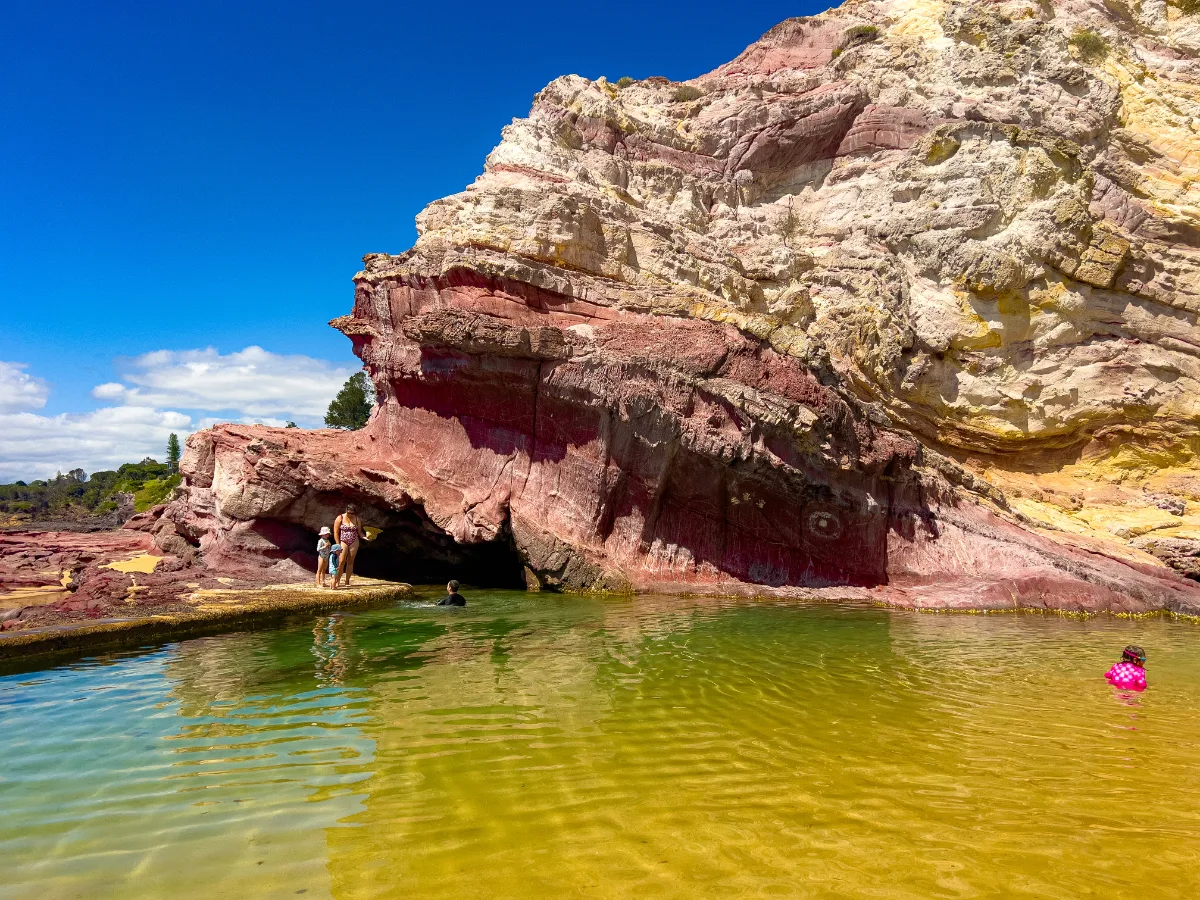 Red rock formations create a stunning contrast with the clear waters of Eden.
