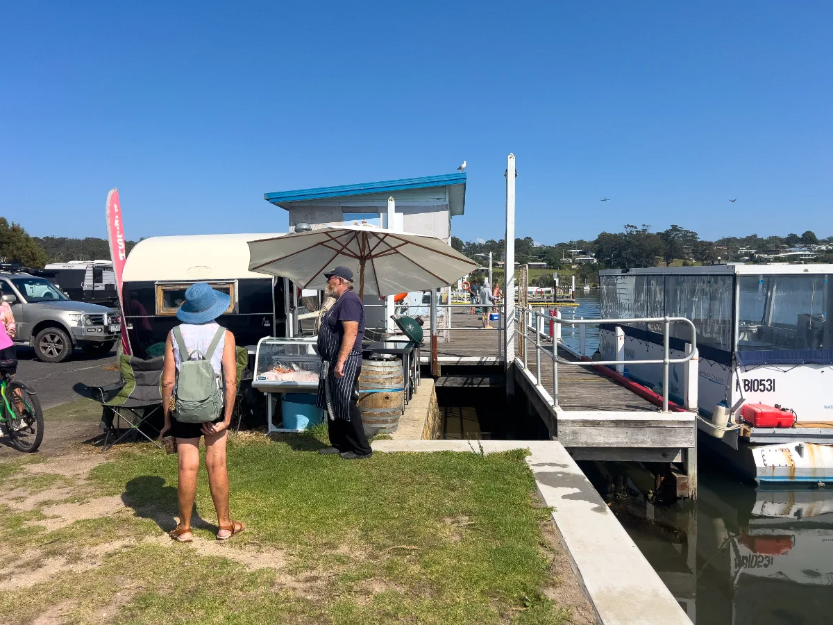 A local fish vendor grilling his daily catch at the Mallacoota market.