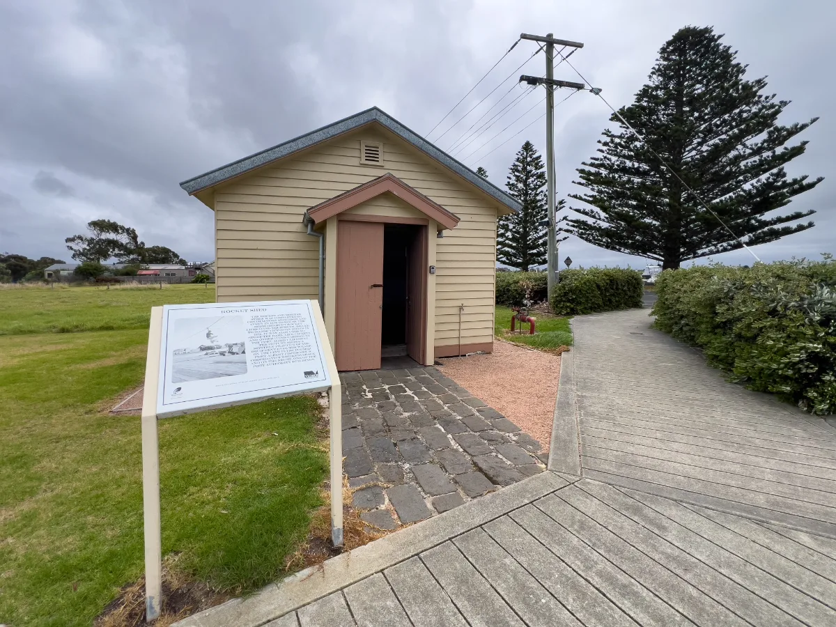 A historic building in Port Albert, with interpretive signage detailing its past.