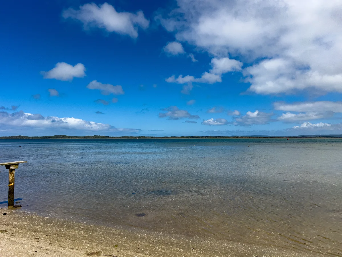 The glassy surface reflects the sky on another perfect day in Yanakie.