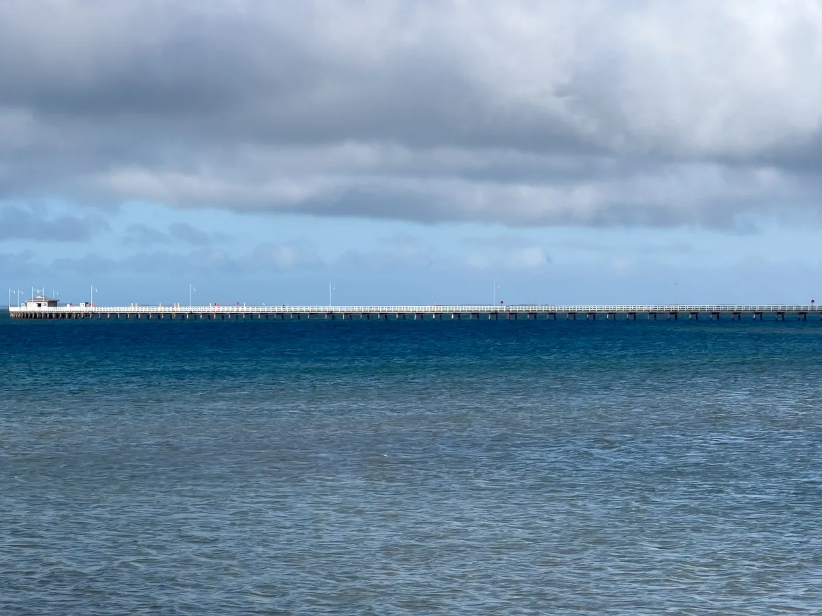 The Long Jetty at Port Welshpool stretches far out into the tranquil waters, a testament to the engineering prowess of a bygone era.