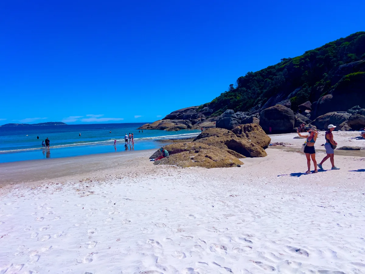 Beachgoers enjoying the sun and surf at Tidal River.