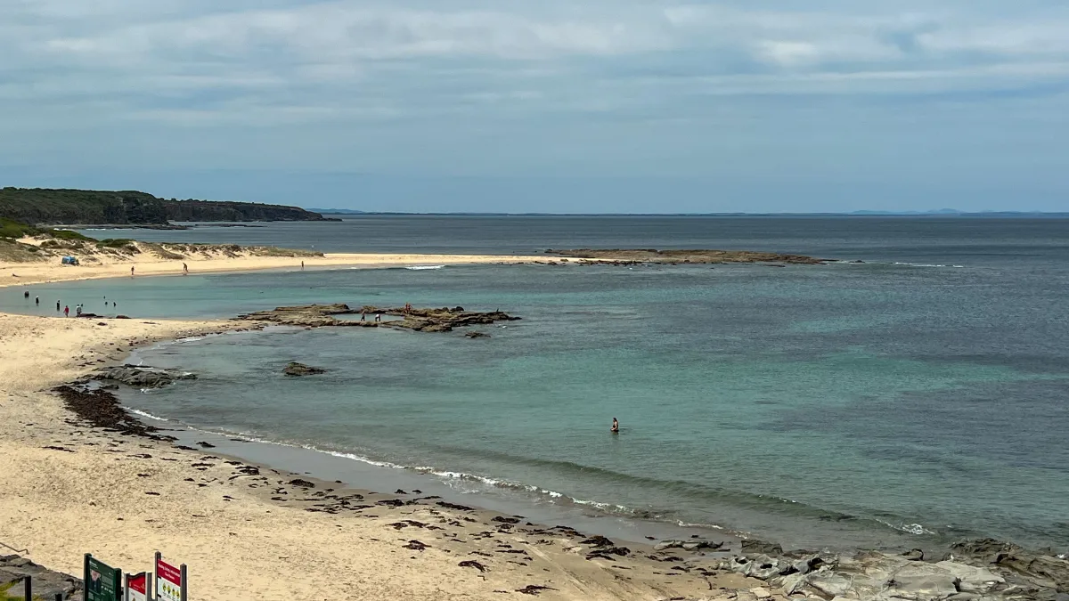 A wide panorama showcasing the serene beaches and tranquil waters of Cape Paterson.