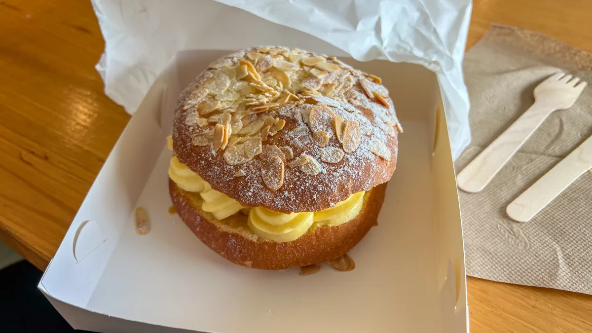 A cream bun, coated in almonds and sugar, the perfect sweet treat.