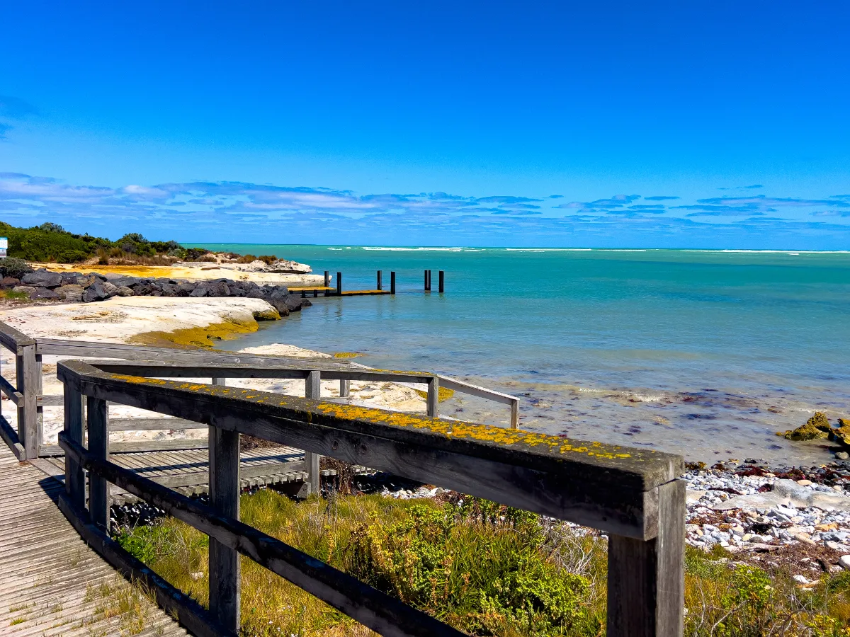 A tranquil cove at Carpenter Rocks, showcasing the crystal-clear waters and rocky seabed.