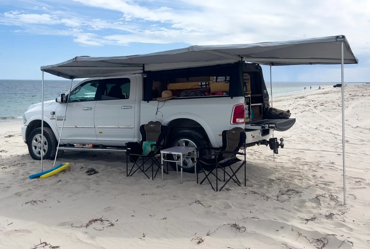 Beachfront setup in Kingston SE: chairs, table, shade, and sand.