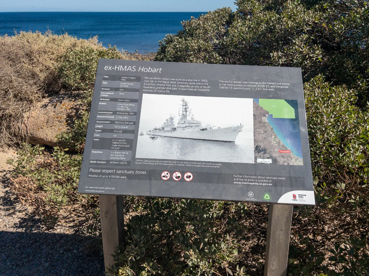 An informational sign detailing the ex-HMAS Hobart's history and specifications, offering a wealth of information for those interested in the ship's past life.