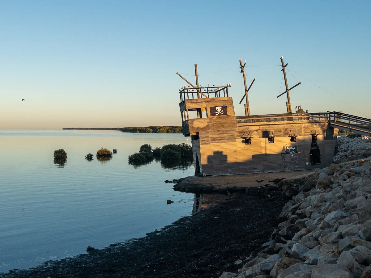 Avast, ye landlubbers! A concrete pirate ship awaits discovery on the shore.