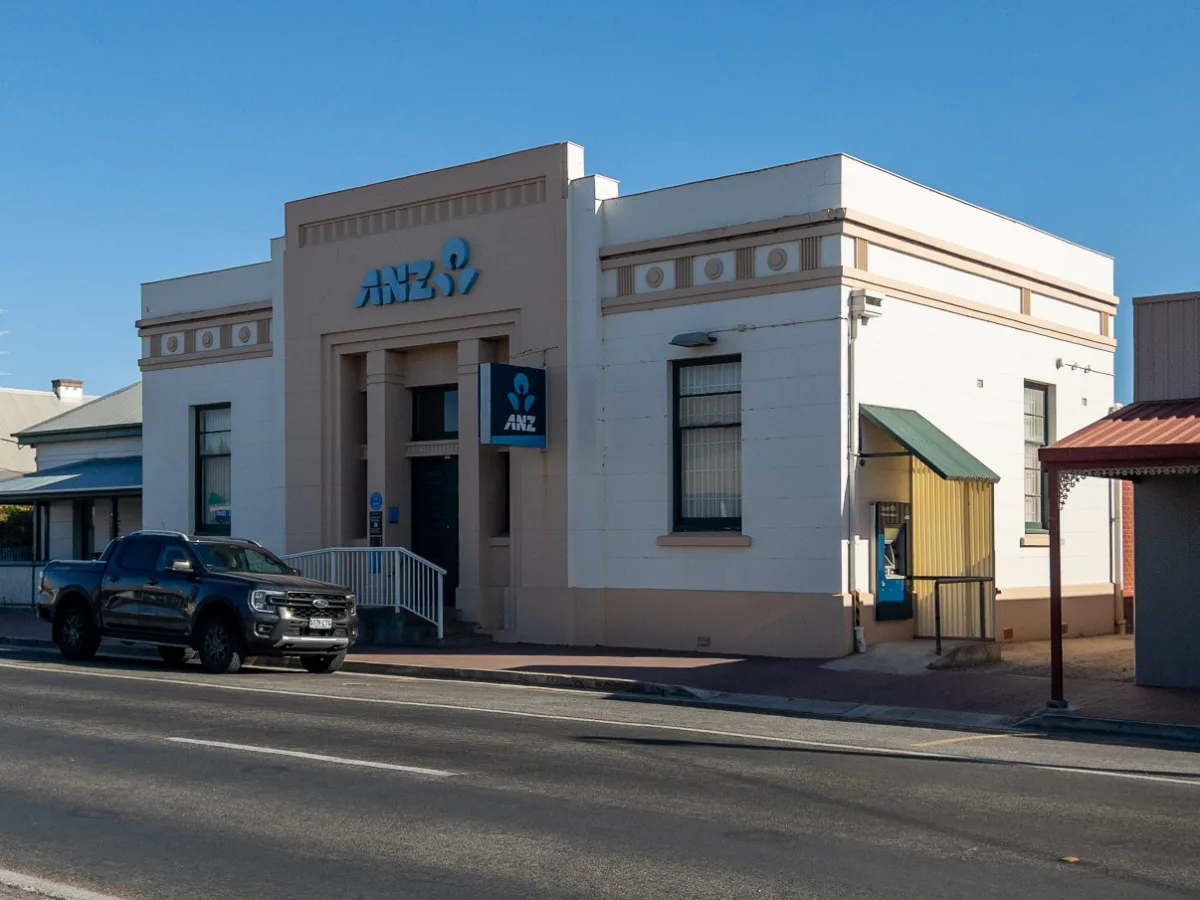 The ANZ bank building, a solid and well-maintained structure reflecting a sense of permanence.