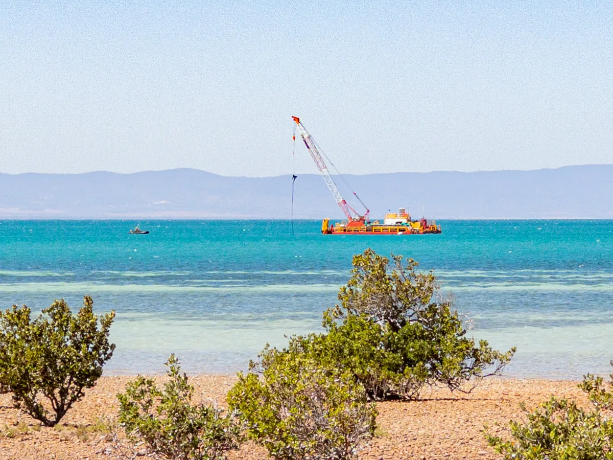 A dredging vessel at work in the Spencer Gulf, seen from the shores of Point Lowly. The constant activity adds a unique, if noisy, element to the coastal landscape.