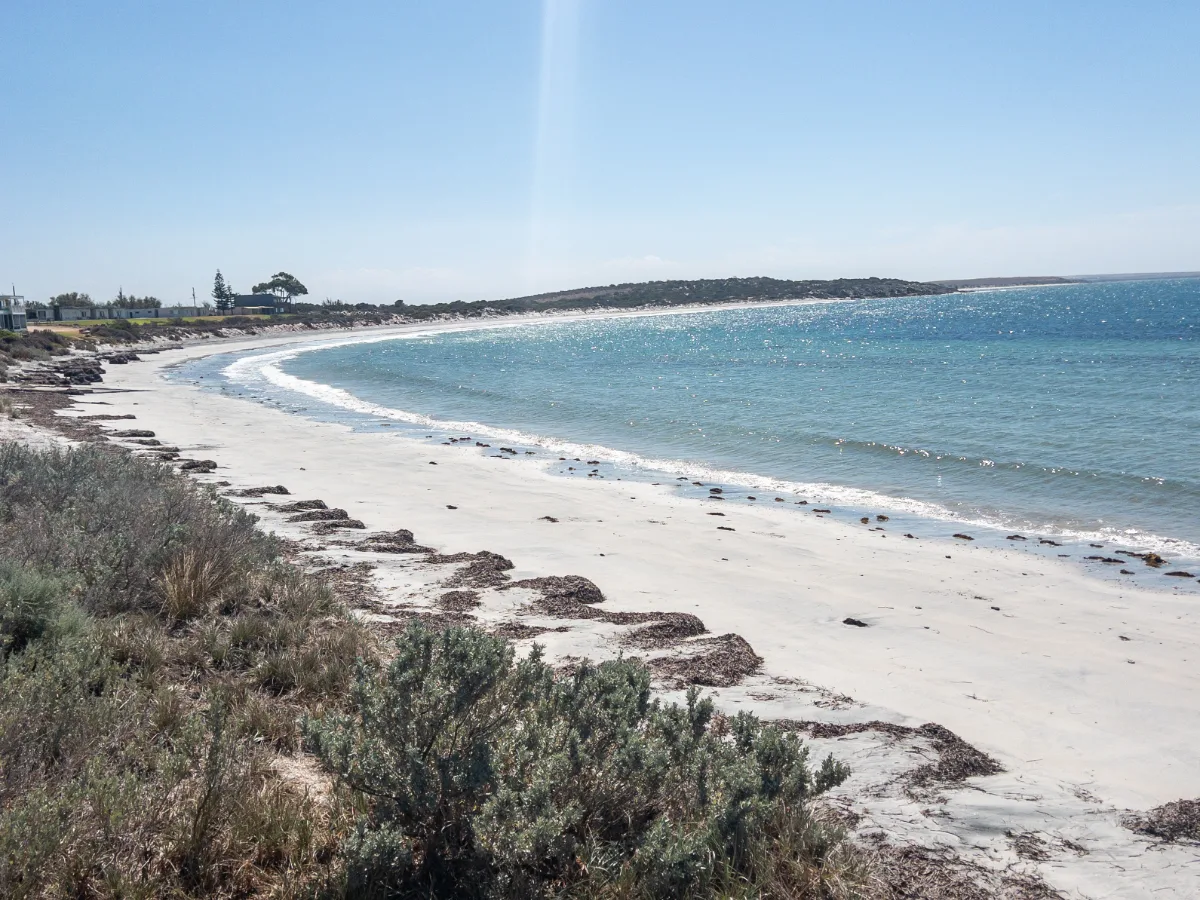 The pristine beach at Port Neill offers a peaceful escape with its clear waters and pale sands.