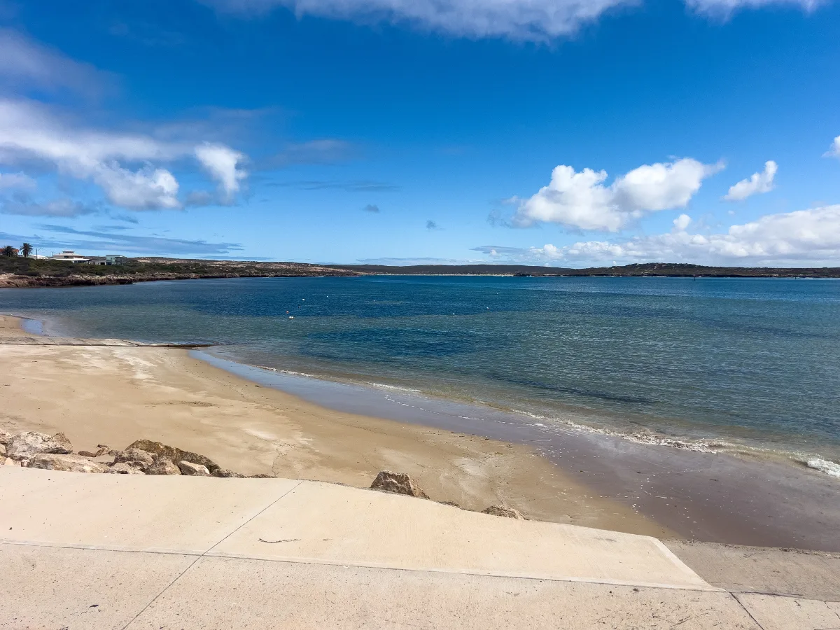 The gentle curve of the beach at Venus Bay, South Australia, inviting visitors for a stroll.