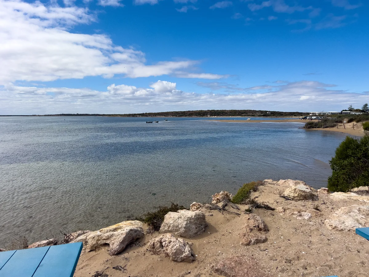 Calm water and a blue sky reflecting off of the bay.